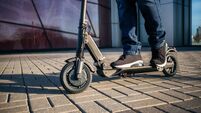 Close up view of legs of man on electric scooter