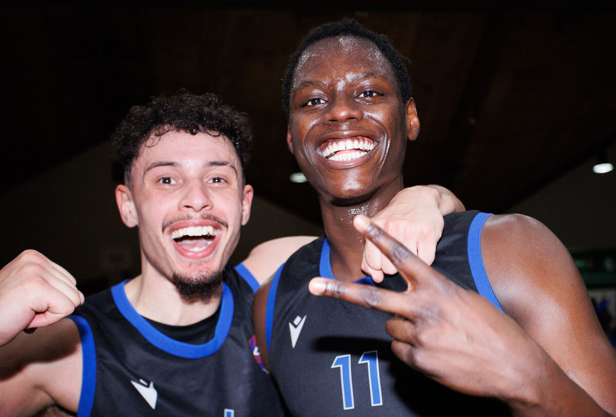 UCC Blue Demons' James Beckom and Tala Fam Thiam celebrate after the game