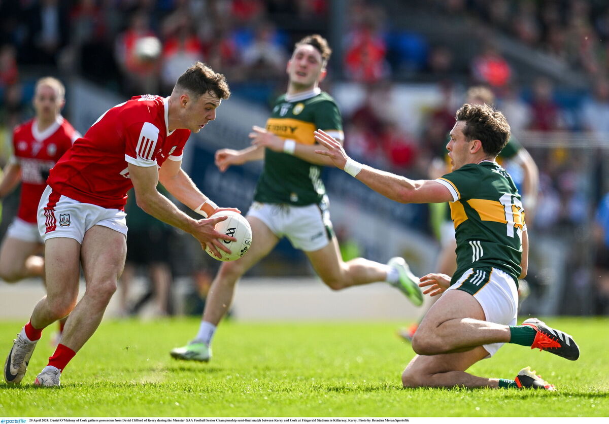 Daniel O'Mahony of Cork gathers possession from David Clifford of Kerry. Picture: Brendan Moran/Sportsfile
