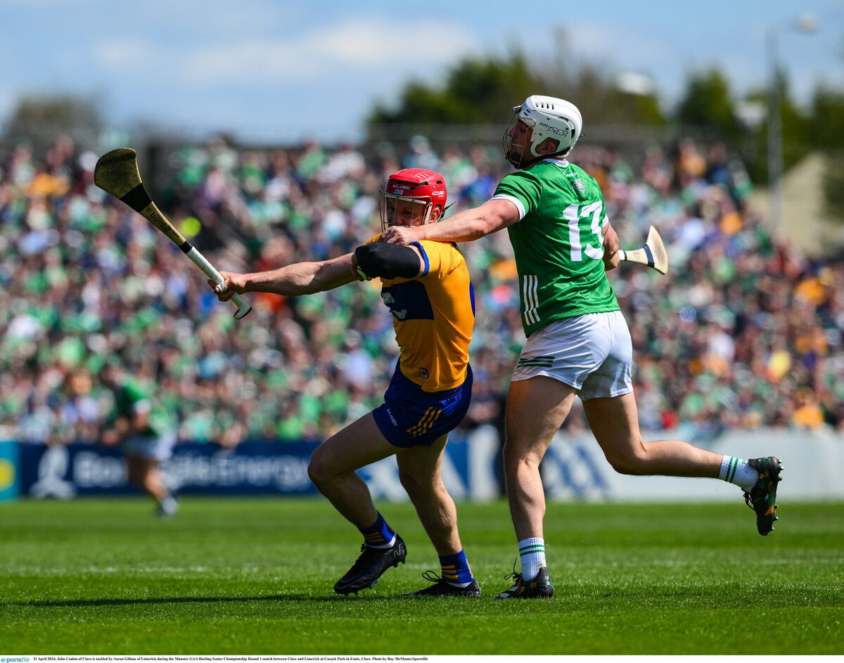 John Conlon of Clare is tackled by Aaron Gillane of Limerick. Picture: Ray McManus/Sportsfile