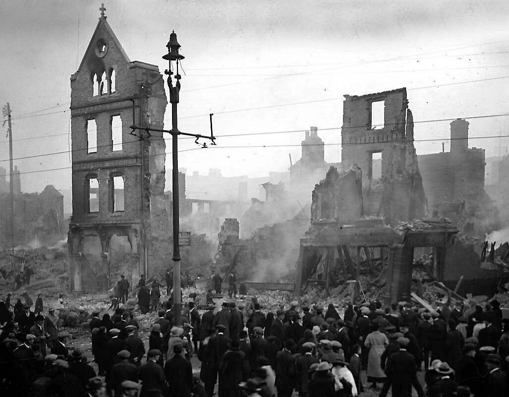 Crowds of onlookers throng Patrick Street on the day following the burning of Cork city centre by crown forces on December 12, 1920. A new novel by Ger Fitzgibbon is based on events that night.