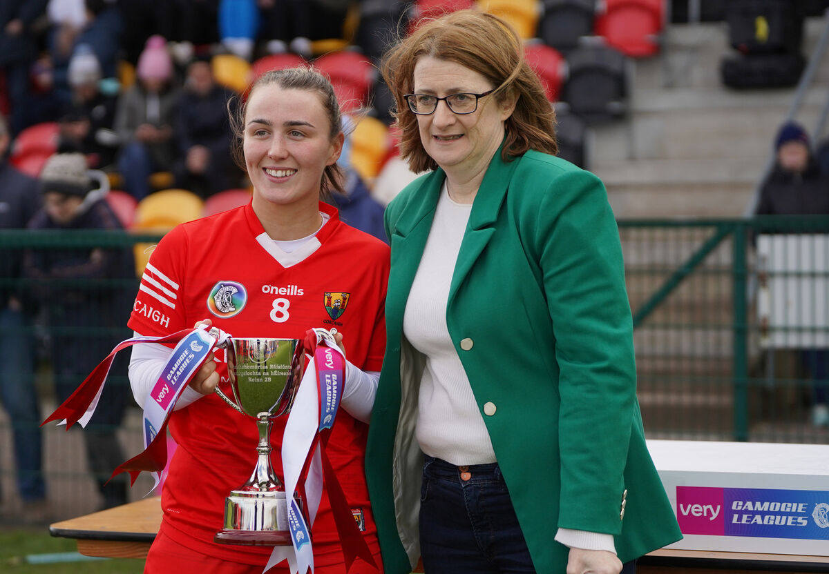 Lauren Homan is presented with the Division 2B League Cup by Hilda Breslin, then president of the Camogie Association, after their win over Tipperary in the final.  Picture: INPHO/Leah Scholes