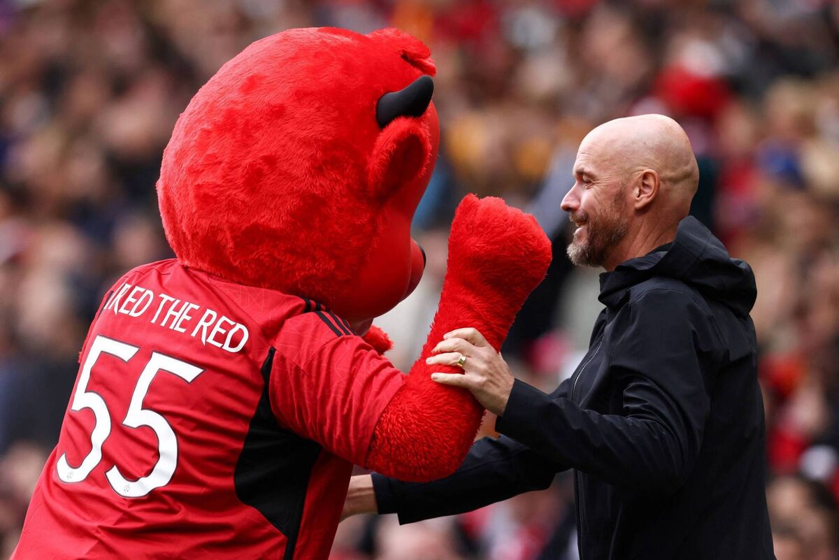 Manchester United's  Erik ten Hag plays with the team mascot  at Old Trafford. United are looking to expand spending as their look to find success with their Ditch manager. Picture DARREN STAPLES/AFP via Getty Images