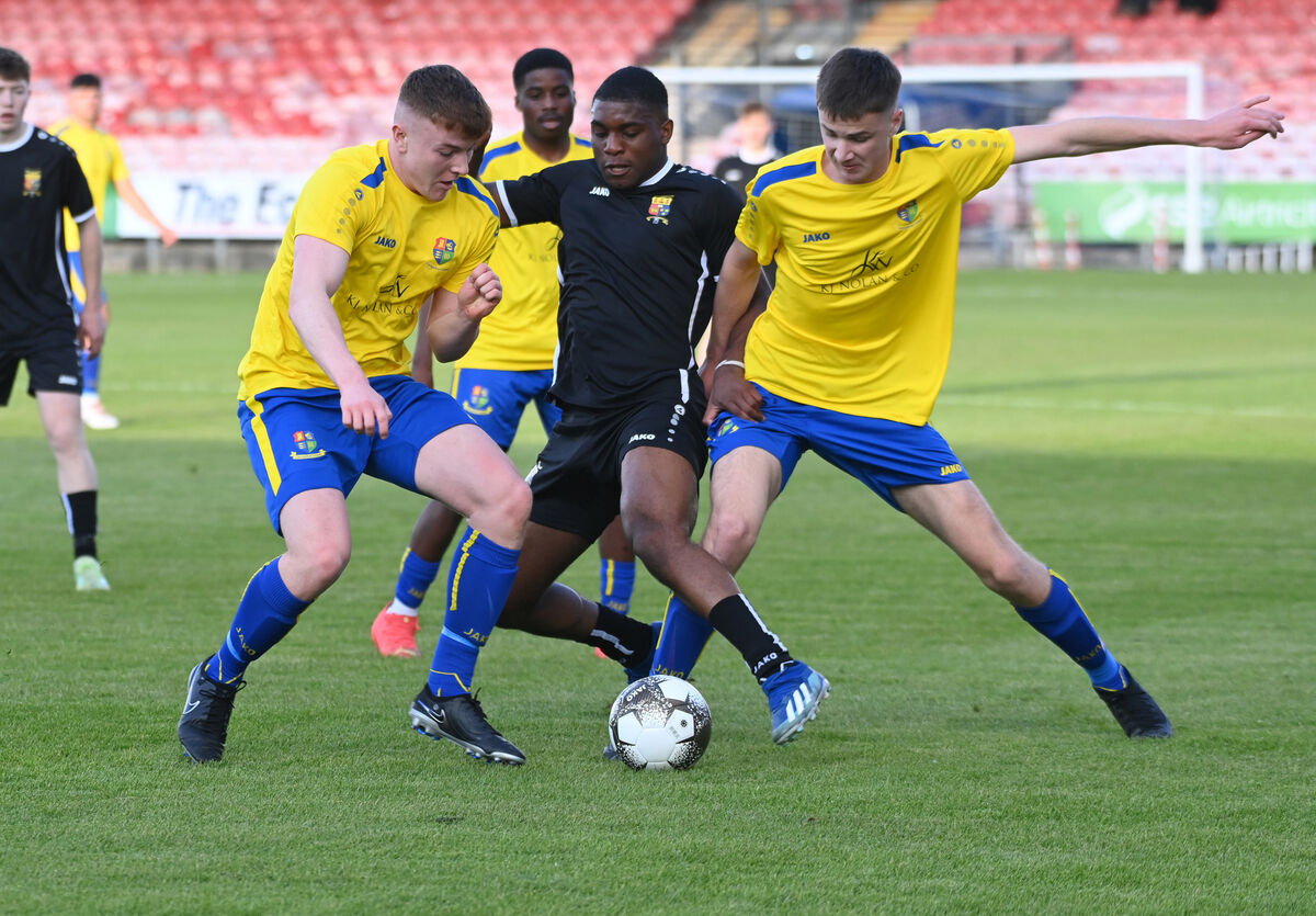 College Corinthians'   Geoffrey Zeph is tackled by Carrigaline United's Eoin McGrath and Dylan Sutton. Picture: Eddie O'Hare