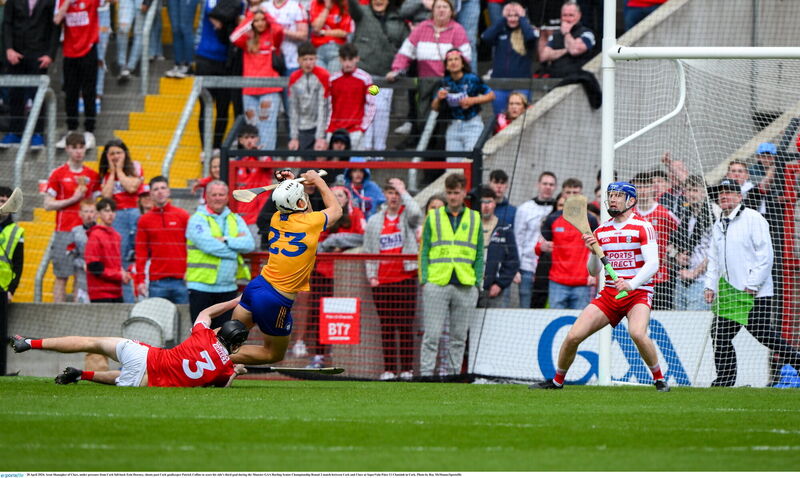 Aron Shanagher of Clare, under pressure from Cork full-back Eoin Downey, shoots past Cork goalkeeper Patrick Collins. Picture: Ray McManus/Sportsfile
