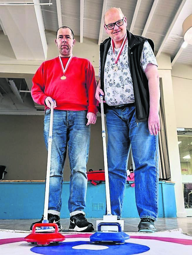 David Hogan and Roger Curtin taking part in the kurling competition at Douglas GAA Club.