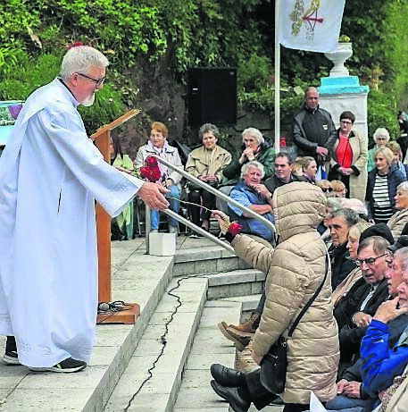 Fr. Pat Fogarty handing out Roses at the 75th anniversary May Sunday procession which took place from St. Joseph's Church, Riverstown to Our Lady of Lourdes Grotto in Glanmire, Co. Cork. - Picture: David Creedon