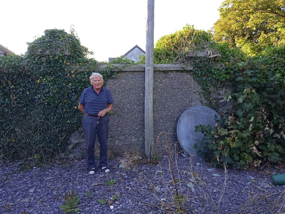 Jeremiah’s son, Michael Collins at the entrance to Burgatia House in August, 2022, where his father entered 99 years earlier to deliver mail - the actual entrance has since been closed
