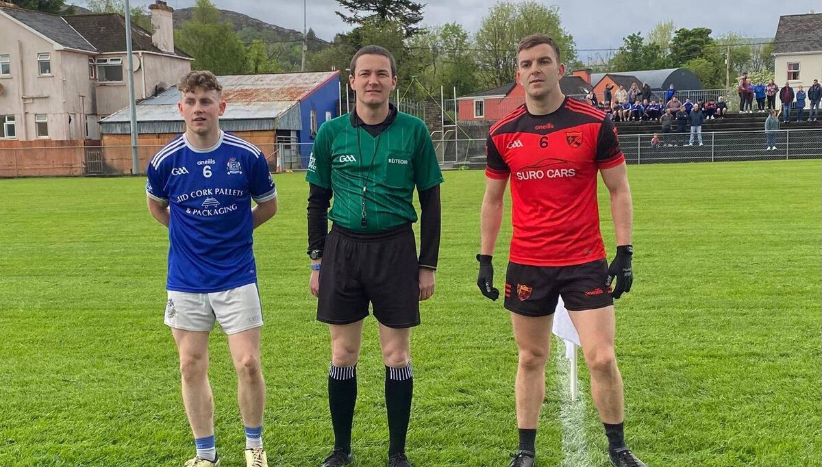 Captains Dara Lynch (Naomh Abán) and Éanna Dineen (Béal Átha'n Ghaorthaidh) with referee David Murnane. Picture: Orla Shorten