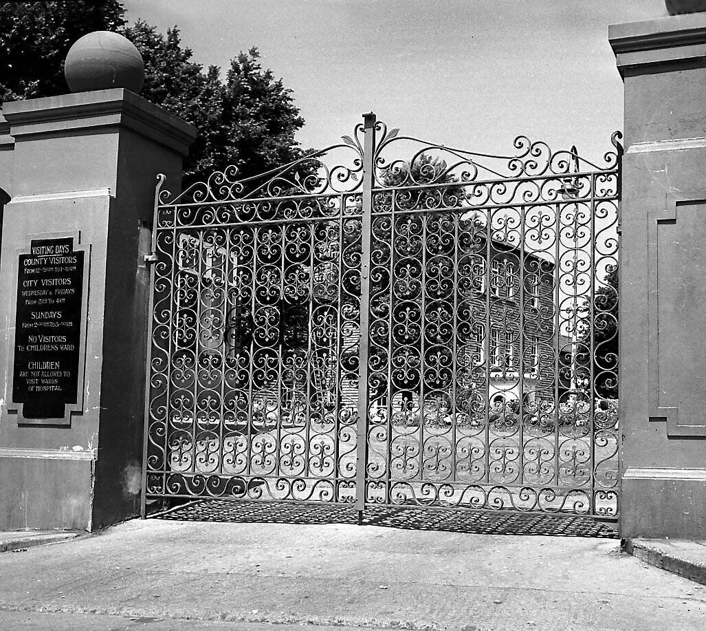The steel front gates of the South Infirmary hospital in 1953. It was originally a mental hospital, later becoming a general hospital The steel front gates of the South Infirmary hospital in 1953. It was originally a mental hospital, later becoming a general hospital