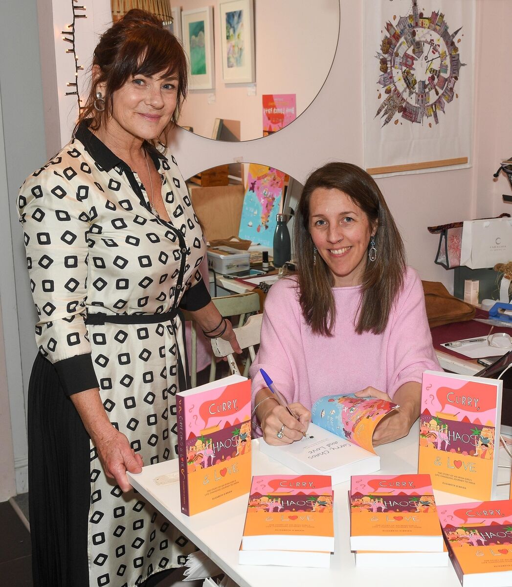  Cork author Elizabeth O'Brien, signing a copy of her book Curry, Chaos and Love, for Esther Weekes owner of Snout, at the launch in Snout, Ballincollig. Picture: David Keane