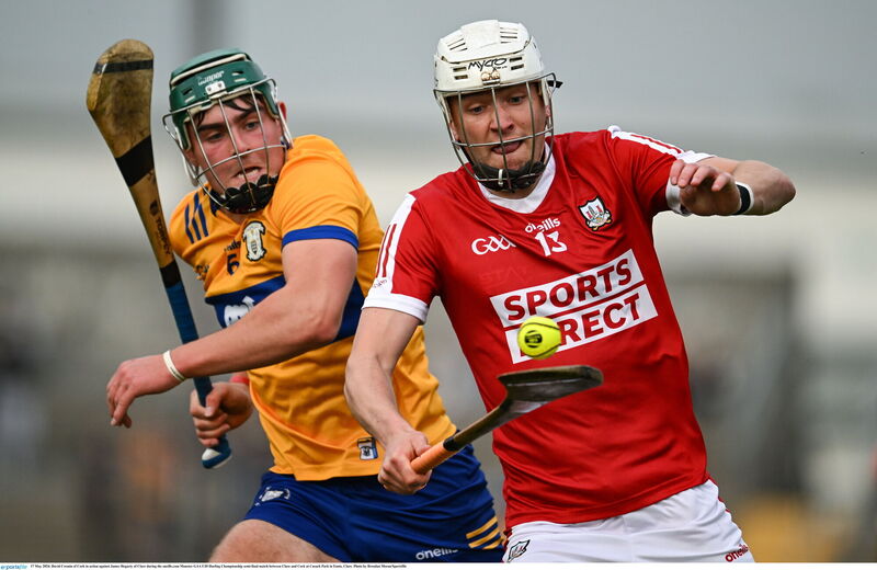Cork's David Cremin shadowed by Clare's James Hegarty. Picture: Brendan Moran/Sportsfile