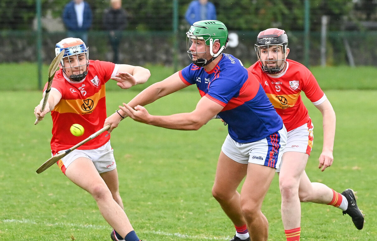Barry Óg Murphy of Erin's Own gets his pass away as Daniel Healy and Eoin Kelleher of Éire Óg close in. Picture: David Keane. Barry Óg Murphy of Erin's Own gets his pass away as Daniel Healy and Eoin Kelleher of Éire Óg close in. Picture: David Keane.