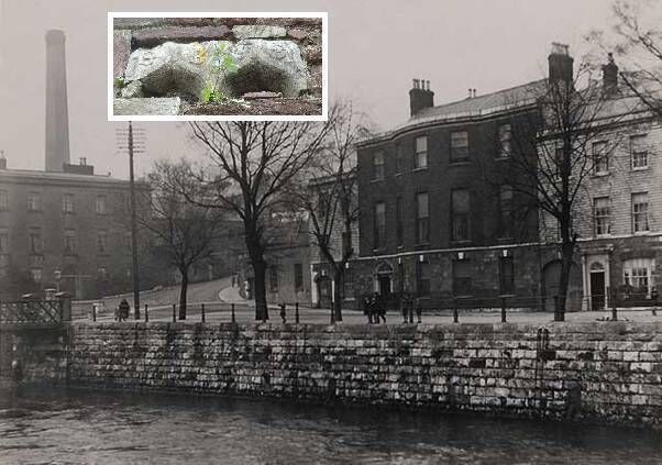 The junction of the North Mall and Wise's Hill, shows the former residence of the Distiller, Francis Wise who with his brother Thomas established a distillery on Reilly’s Marsh in 1779. In the background is the 19th century 160 ft high distillery stack. Adjacent to the house is the old distillery wall running up Wise’s Hill which is a remanet of the old red-sandstone wall and loading granary docks of the distillery. Photograph: Courtesy: Cork Camera Club Collection, Cork City Library Insert Photograph of ancient stone mullion: Richard T. Cooke.