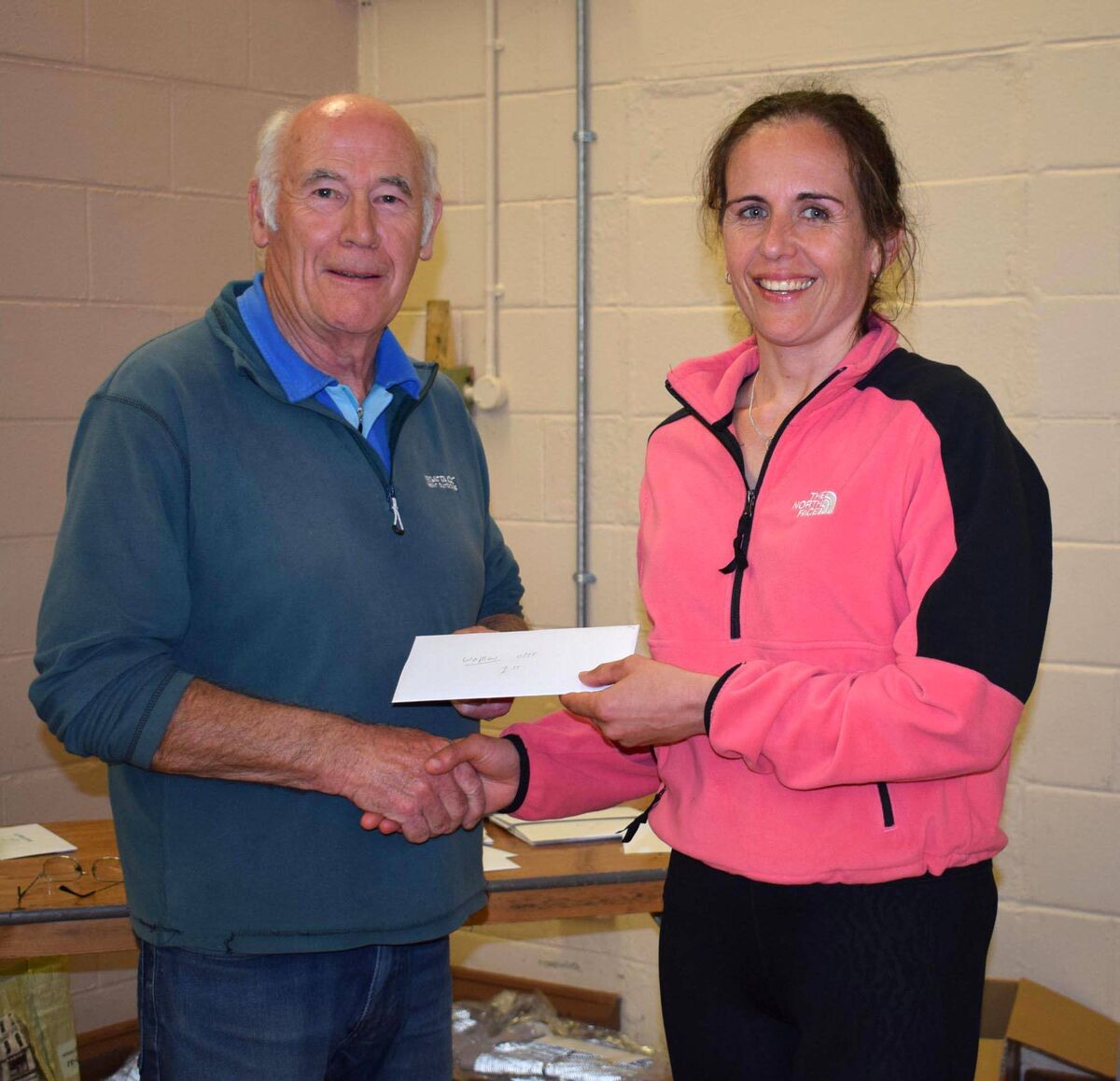 Former international rower Orla Hayes, sixth in the women's race and first in the F35 category at the Pfizer race, receiving her prize from Kevin O'Driscoll. Picture: John Walshe 