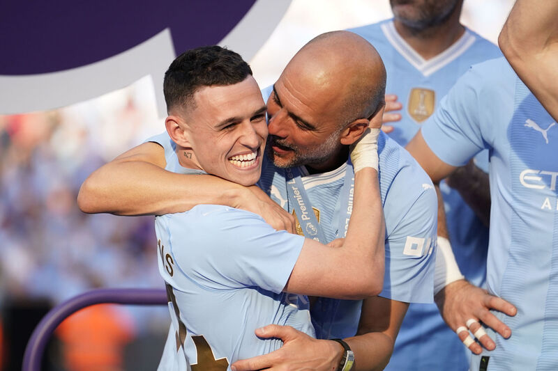 Manchester City's head coach Pep Guardiola, right, celebrates with Manchester City's Phil Foden at the end of the English Premier League season. Picture: AP Photo/Dave Thompson