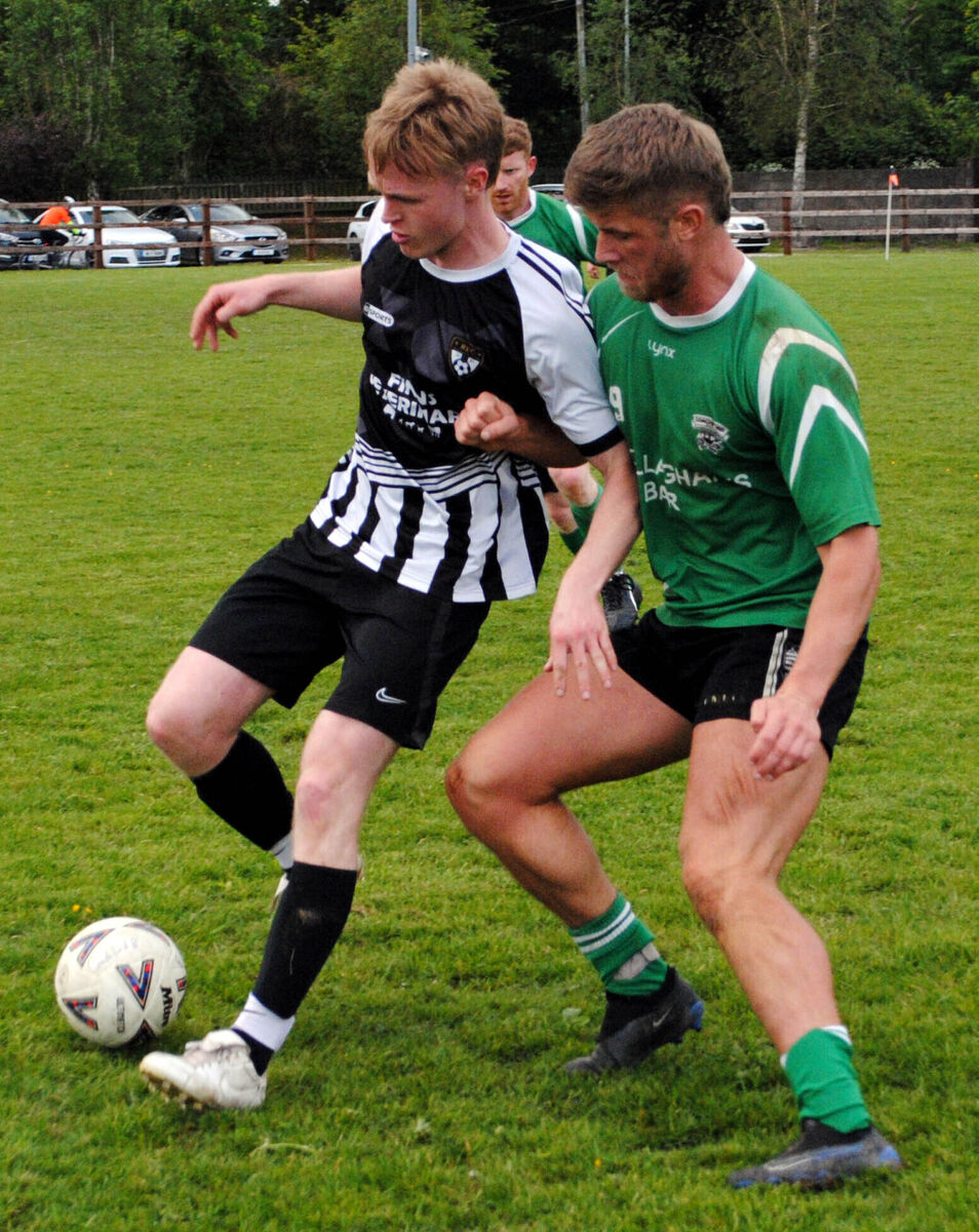 Rathcormac's Ciaran Crowley keeps the ball under control as he is challenged by Coachford B's Billy Barrett.