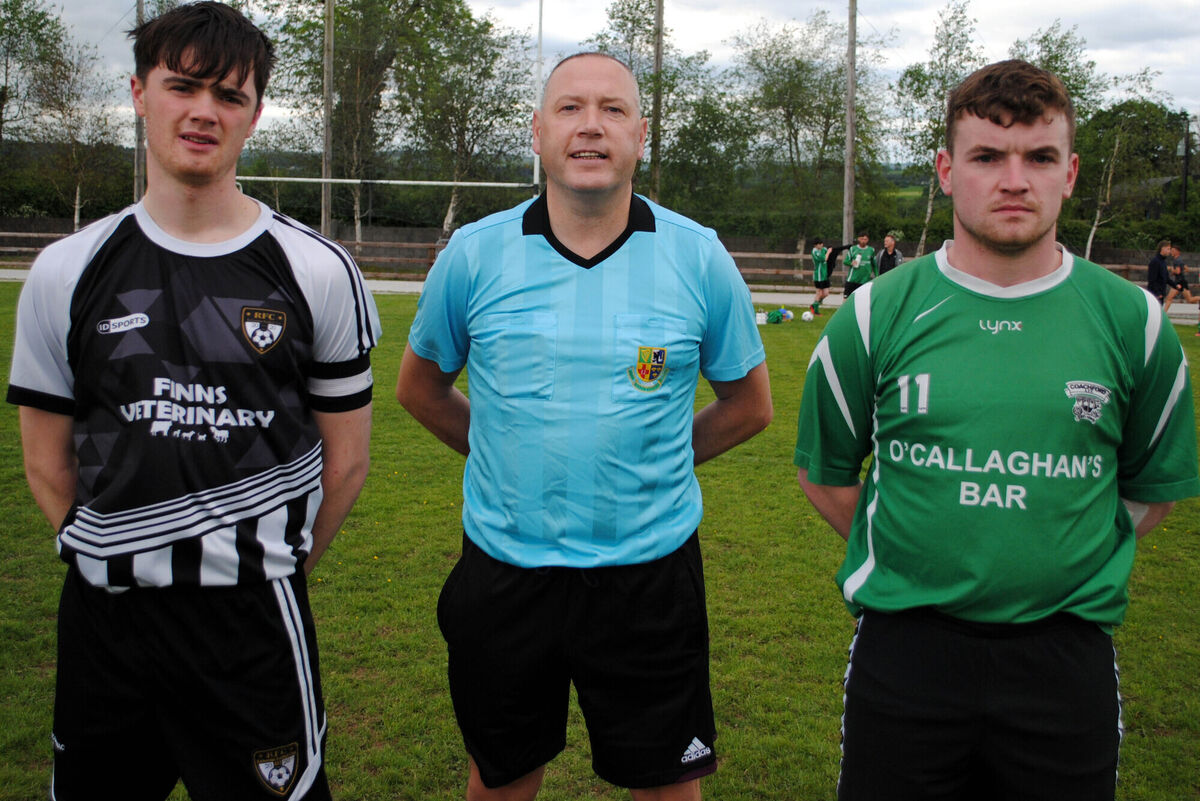 Rathcormac's captain Richard Morrisson (left) with Coachford B's Tadgh Bradley, accompanied by referee Alan McDonagh.