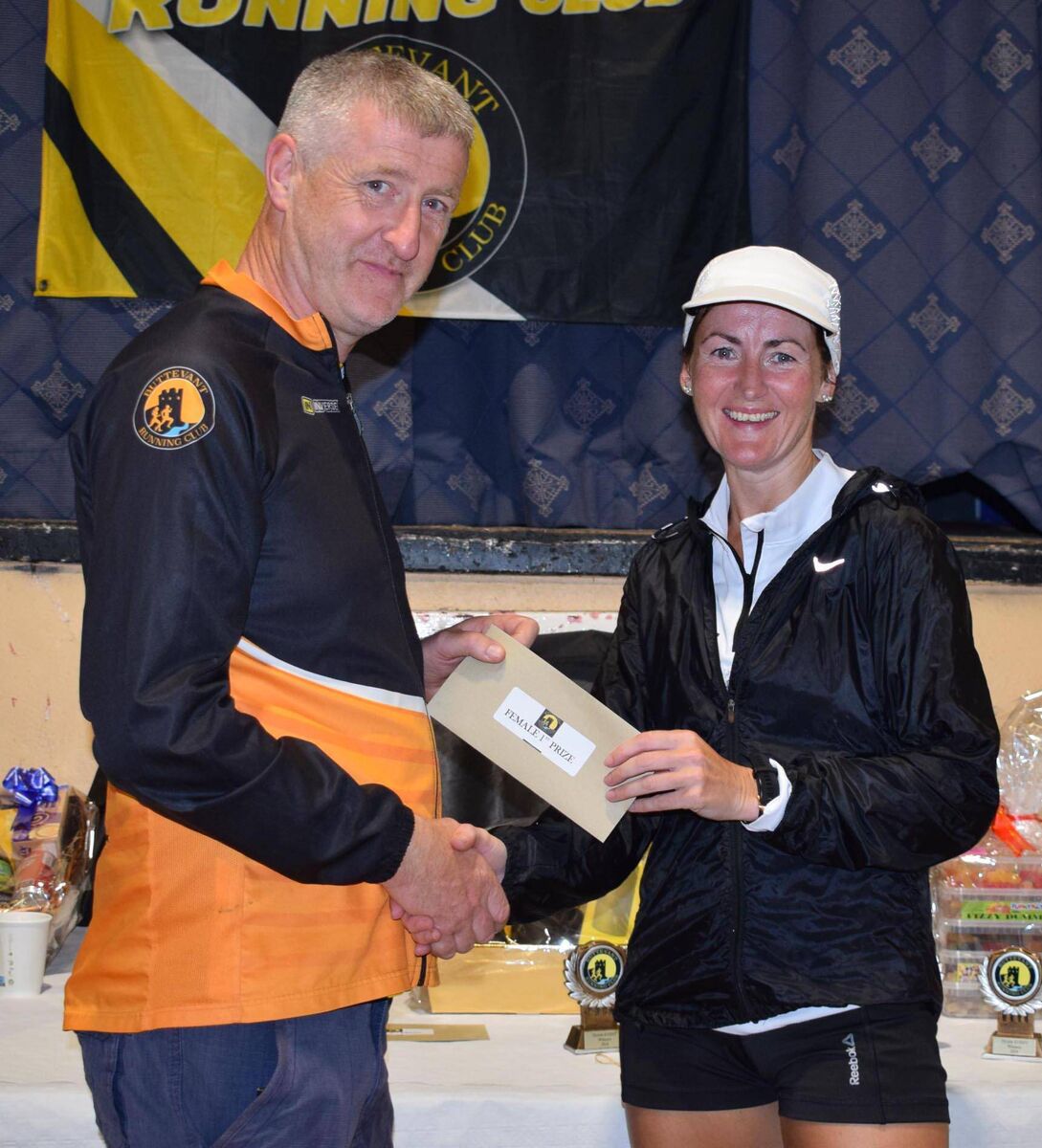 Michelle Finn, first in the women's race at Buttevant, receiving her prize from James Breen, Chairman of Buttevant RC. Picture: John Walshe 
