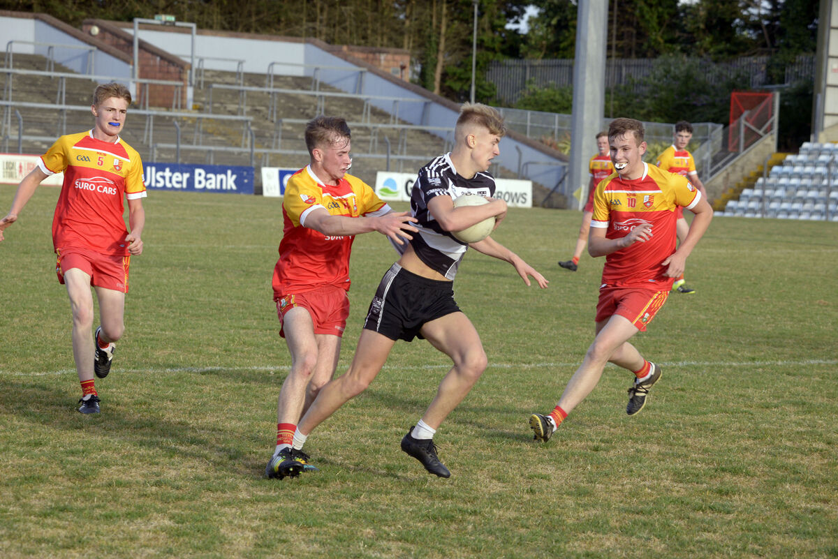 Donoughmore's Billy Barrett being tackled by Eoin O'Donovan of Tadhg MacCarthaigh in the County U21 C football championship final at Páirc Uí Rinn in 2018. Picture: Denis Boyle