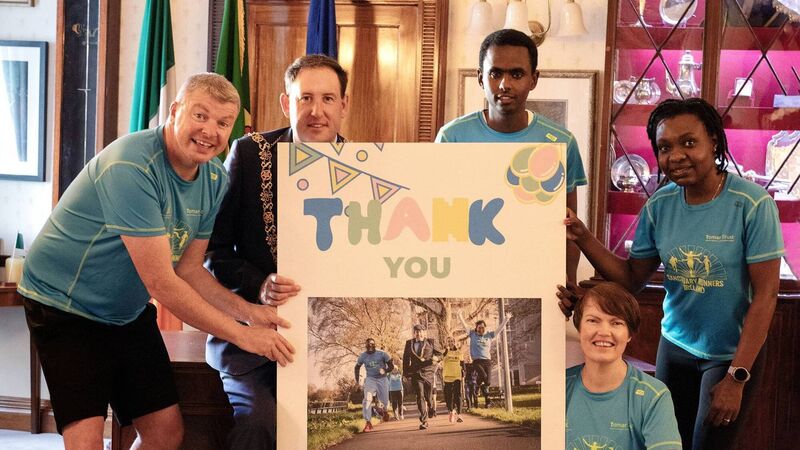 Cork's Sanctuary Runners present giant 'thank you' card to Lord Mayor