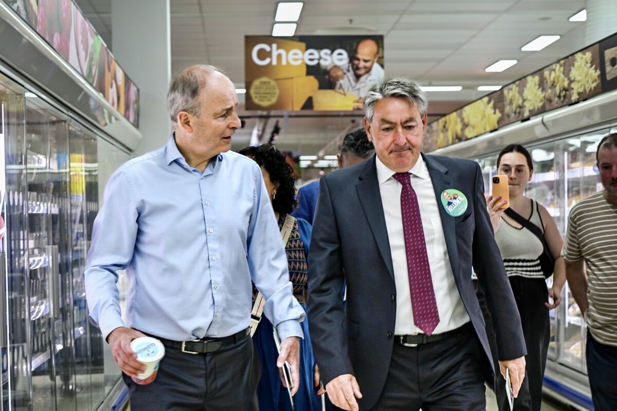 Tánaiste Micheál Martin and Billy Kelleher take a walk down the Tesco’s cheese aisle while canvassing in Douglas Village shopping centre on Saturday. Picture Chani Anderson