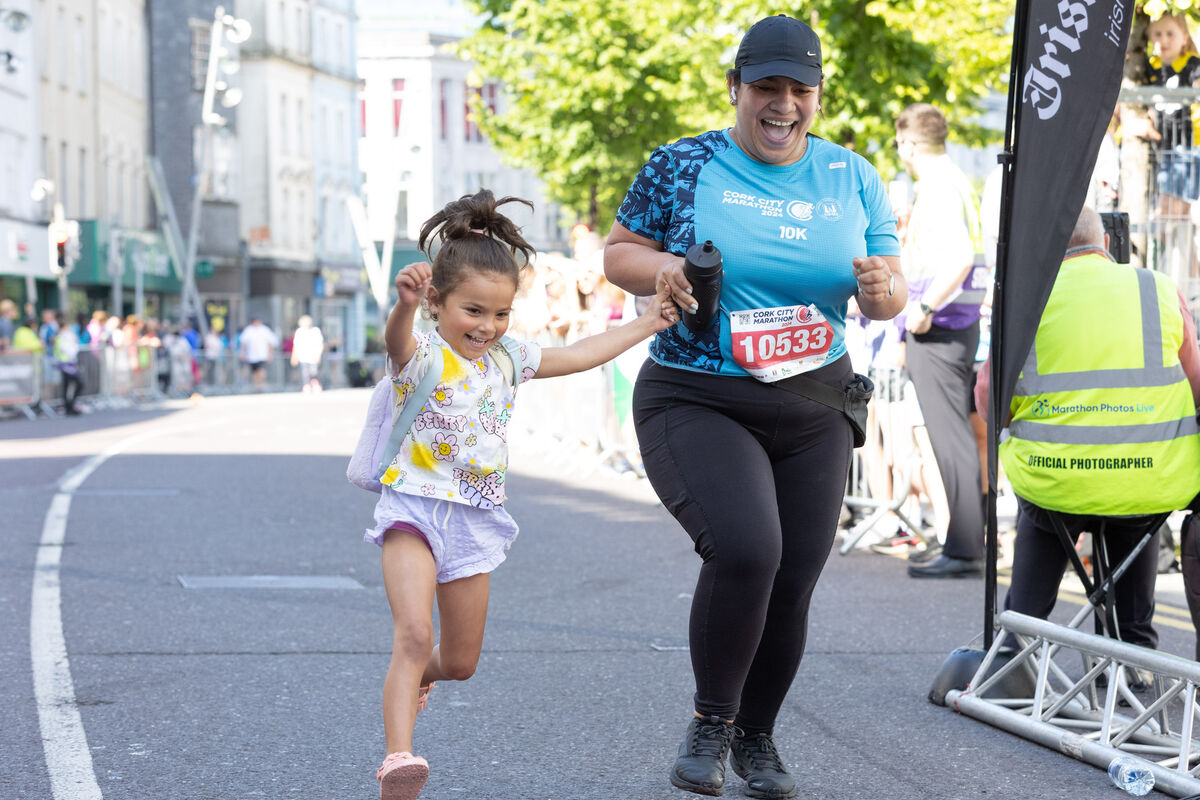 Gaby Patino from Carrigaline crossing the finish line of the 10K with her daughter Meghan Martinez, Carrigaline at the Cork City Marathon. 