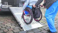 Wheelchair user on accessible car ramp