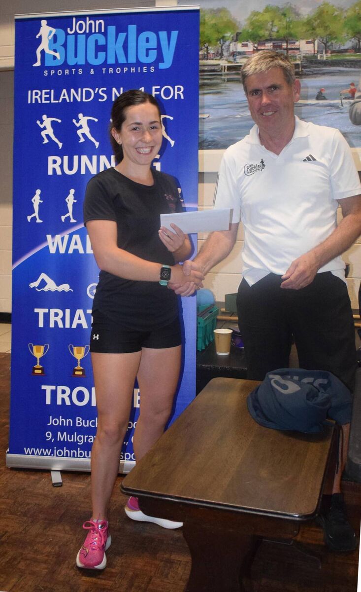 Holly Carroll, first in the women's race at the John Buckley Sports 5km, receiving her prize from Conor Kavanagh of John Buckley Sports. Picture: John Walshe Holly Carroll, first in the women's race at the John Buckley Sports 5km, receiving her prize from Conor Kavanagh of John Buckley Sports. Picture: John Walshe