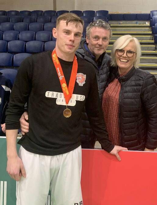 Daragh Fleming with his parents, Paul and Catherine at the National Stadium after winning a Division1 National Cup with Ballincollig basketball club.