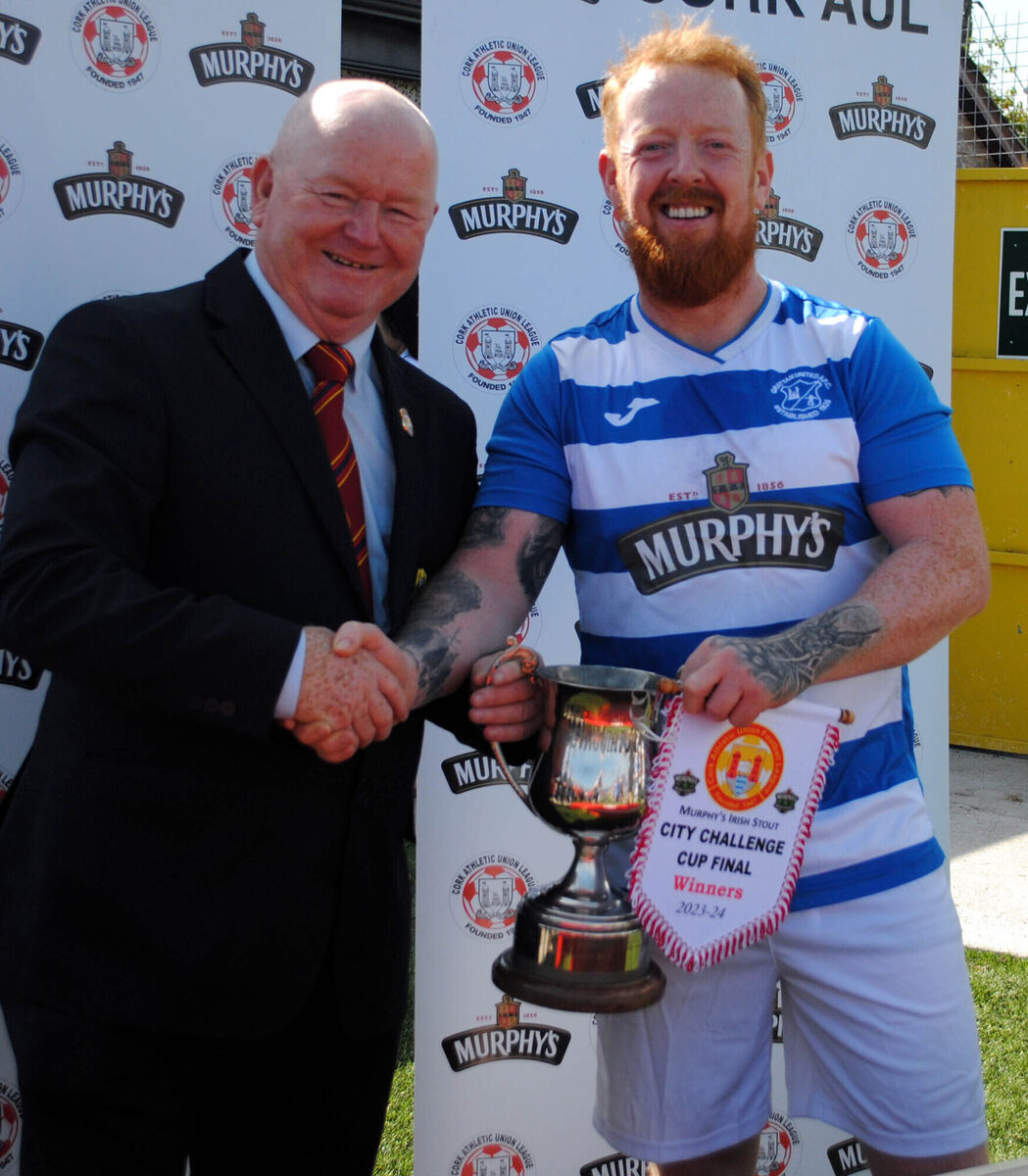 Denis Crowley (Cork AUL) presents the City Challenge Cup to Grattan B's captain Richie O'Hare. Picture: Barry Peelo.