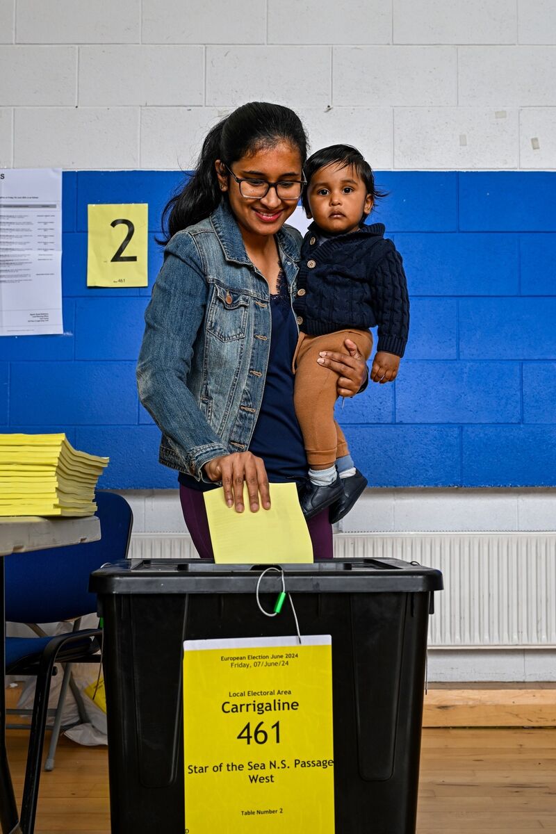 Krish Vadivel helps his mother Ramyaa from Passage West cast her vote. Picture Chani Anderson Krish Vadivel helps his mother Ramyaa from Passage West cast her vote. Picture Chani Anderson