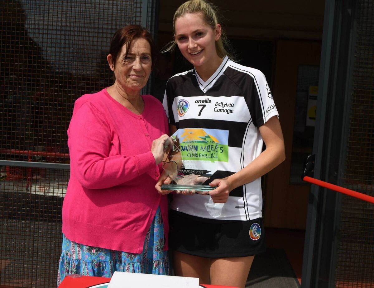 Laura Dundon, Ballyhea captain is presented with the Premier Intermediate camogie trophy by Mairead Donovan, chairperson Cork camogie board. Laura Dundon, Ballyhea captain is presented with the Premier Intermediate camogie trophy by Mairead Donovan, chairperson Cork camogie board.