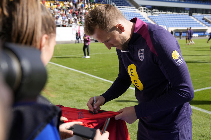 England's Harry Kane signs autographs after a public open training session at Jena Stadium in Jena, Germany. Picture:AP Photo/Thanassis Stavrakis)