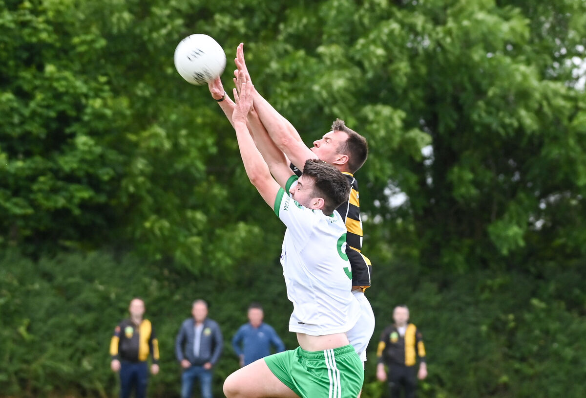  Avondhu's Anthony O'Neill and Muskerry's Jack O'Donoghue compete in the air. Picture: David Keane