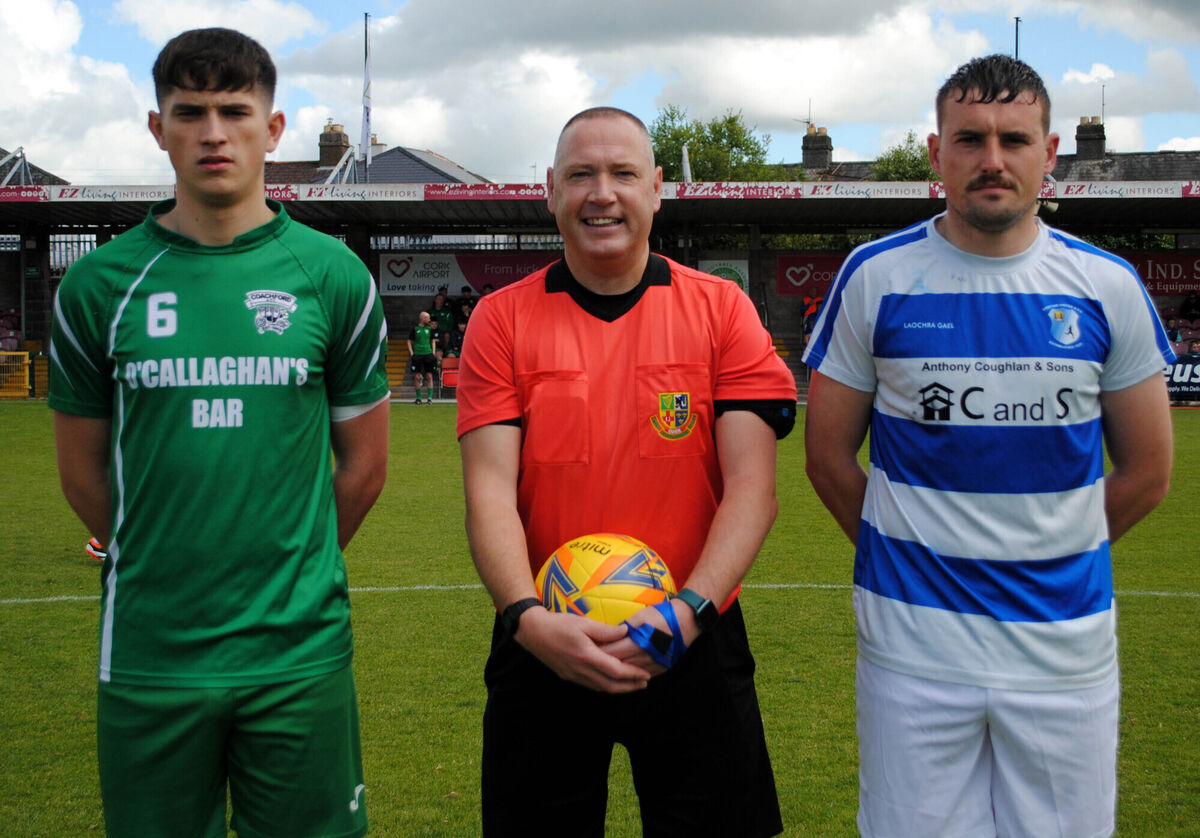 Coachford's Adam Murphy (left) with Grattan United's Dean Murray, accompanied by referee Alan McDonnagh.