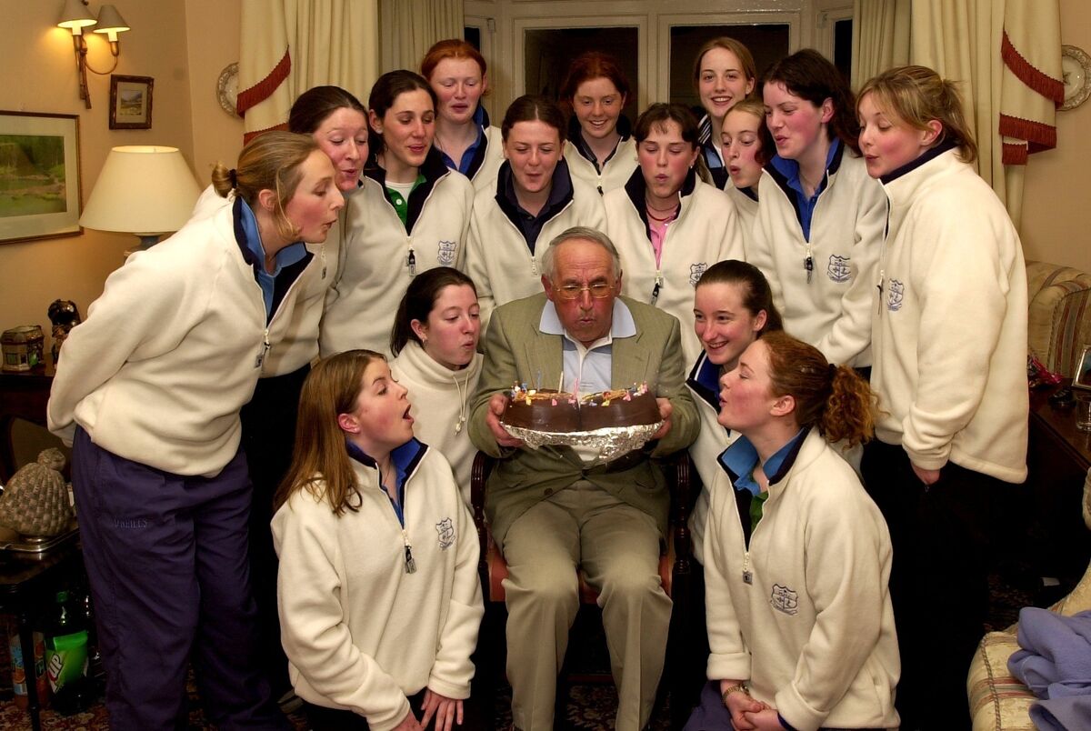 Coach Cyril Daunt and and his Mount Mercy Hockey team help Cyril blow out his 75th birthday candles