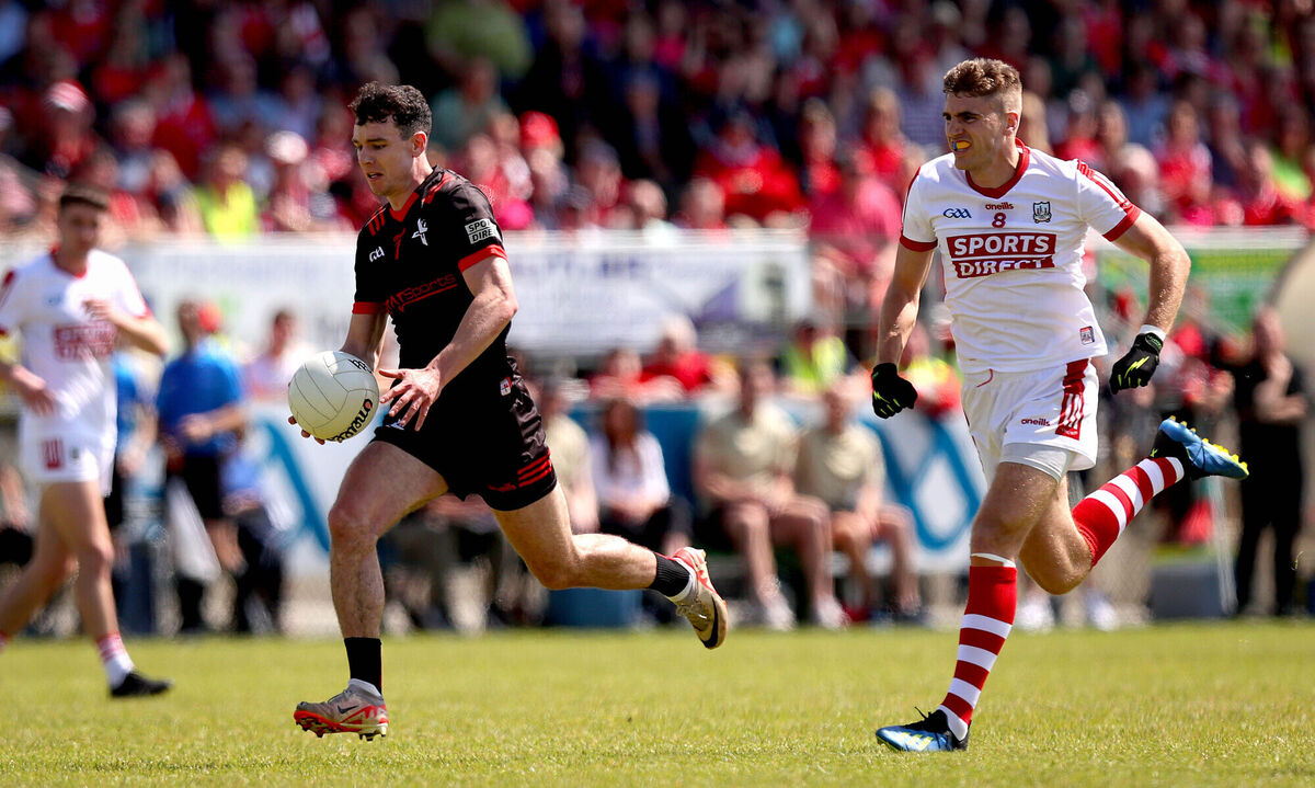 Louth’s Craig Lennon is pursued by Ian Maguire of Cork. Picture: INPHO/Ryan Byrne