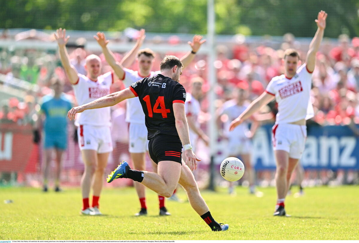 Sam Mulroy of Louth kicks the match winning point from a free against Cork. Picture: Ben McShane/Sportsfile