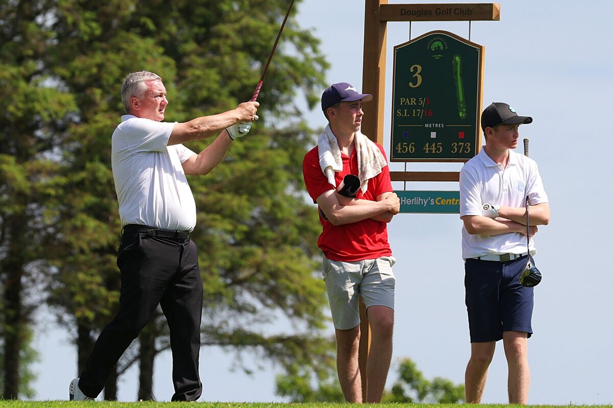 Castlemartyr's John O'Brien tees off the 3rd hole in Douglas, watched by Cork's Paddy Quill. Picture: James Doolan