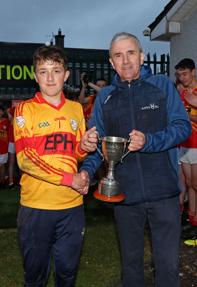 Tomas O'Brien, Éire Óg, receives the cup from Michael O'Mahony. Picture: Jim Coughlan.  Tomas O'Brien, Éire Óg, receives the cup from Michael O'Mahony. Picture: Jim Coughlan.