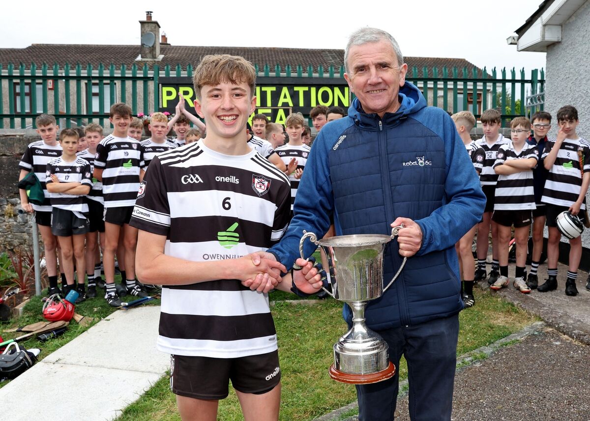 Liam O'Sullivan, Midleton, receives the Premier 2 Cup from Michael O'Mahony. Picture: Jim Coughlan.  Liam O'Sullivan, Midleton, receives the Premier 2 Cup from Michael O'Mahony. Picture: Jim Coughlan.