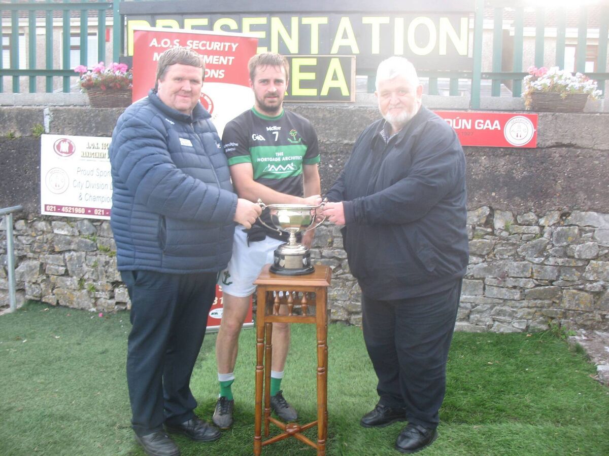 Derek Connolly (Assistant Secretary Seandún) and Bernard Corcoran (Seandún Referees Co-ordinator) presenting the trophy to Nemo Rangers winning captain Conor Allen. Derek Connolly (Assistant Secretary Seandún) and Bernard Corcoran (Seandún Referees Co-ordinator) presenting the trophy to Nemo Rangers winning captain Conor Allen.