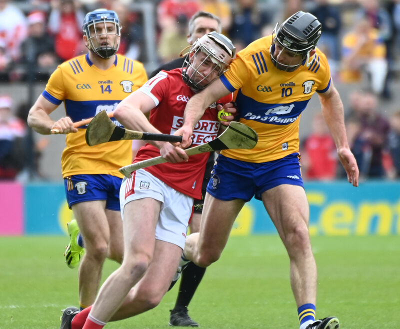Ethan Twomey, seen here holding off Clare's Cathal Malone in April, is back on the bench for Cork. Picture: Eddie O'Hare