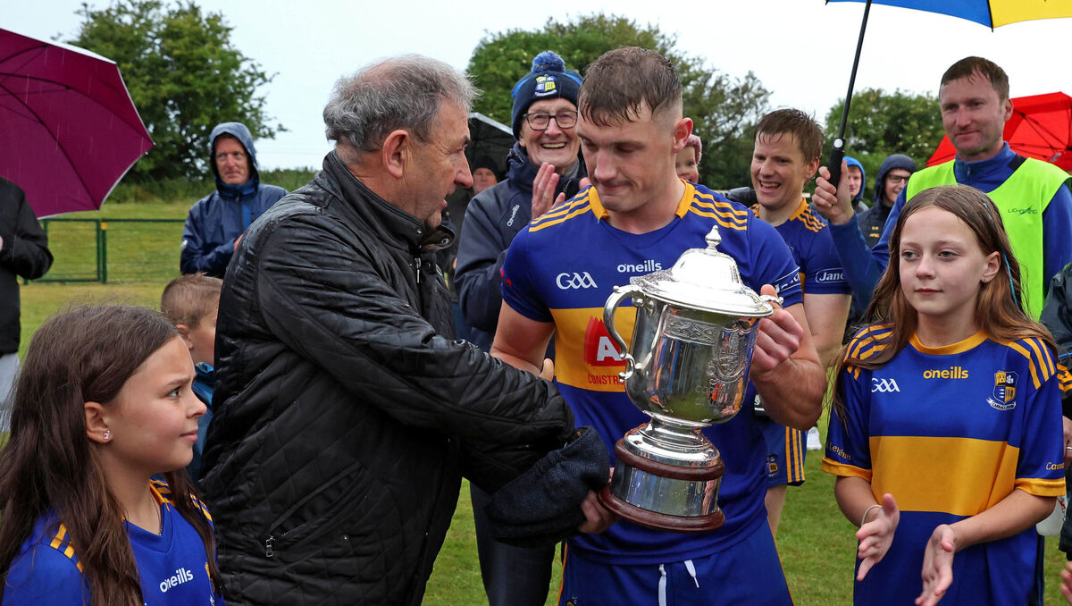  Denis Harrington, Cork County Board, presents the Bryan O'Loughlin Cup to Jack McCarthy, Carrigaline. Picture: Jim Coughlan