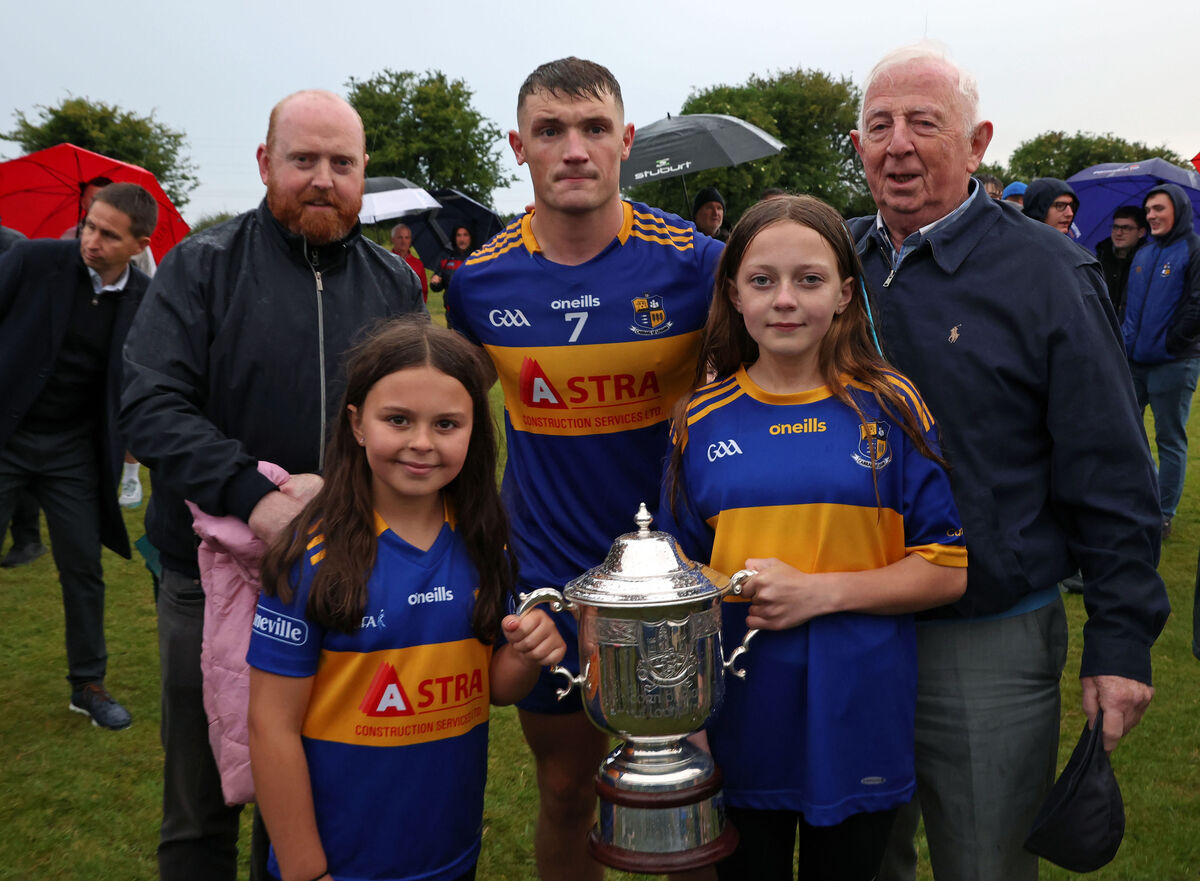  Jack McCarthy, Carrigaline captain, with Bryan O'Loughlin family members and the Bryan O'Loughlin Cup after the win over Nemo Rangers. Picture: Jim Coughlan