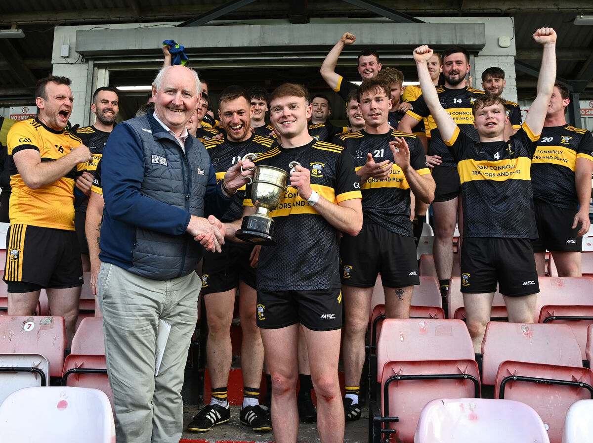 County board chairman Pat Horgan prresensthe trophy to Goleen captain Padraig Reidy after their win over Ballyphehane in the McCarthy Insurance Group J'B'FC final at Pairc Ui Rinn. Picture: Eddie O'Hare