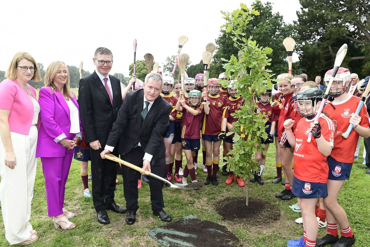 Junior Minister Kieran O'Donnell TD sets an oak tree in the company of Hilda Breslin, former President, Camogie Assoication; Helen O'Rourke, CEO Ladies Football; Tom Ryan, Director Genreral GAA with the support of boys and girls to acknowledge the 1893 All Ireland Final stagings in the Phoenix Park. Picture John Tarrant
