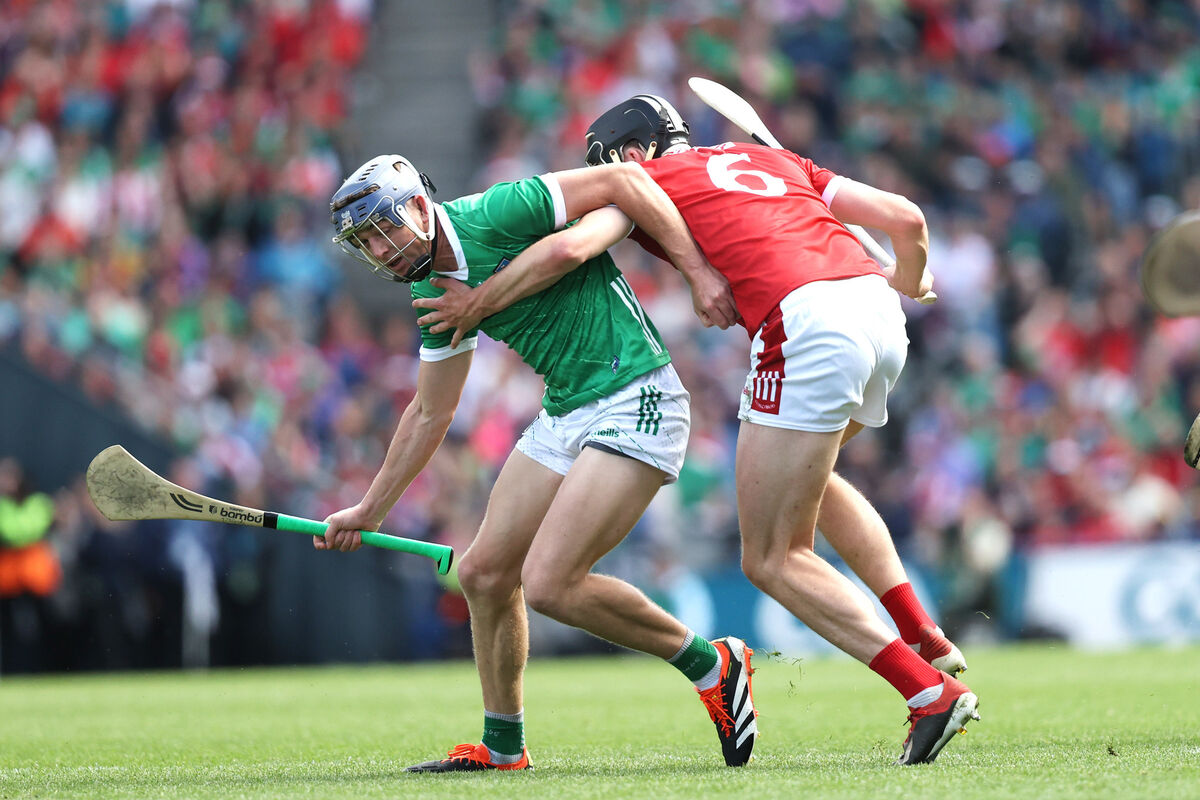 Robert Downey of Cork gets to grips with Limerick's David Reidy. Picture: Inpho/Bryan Keane