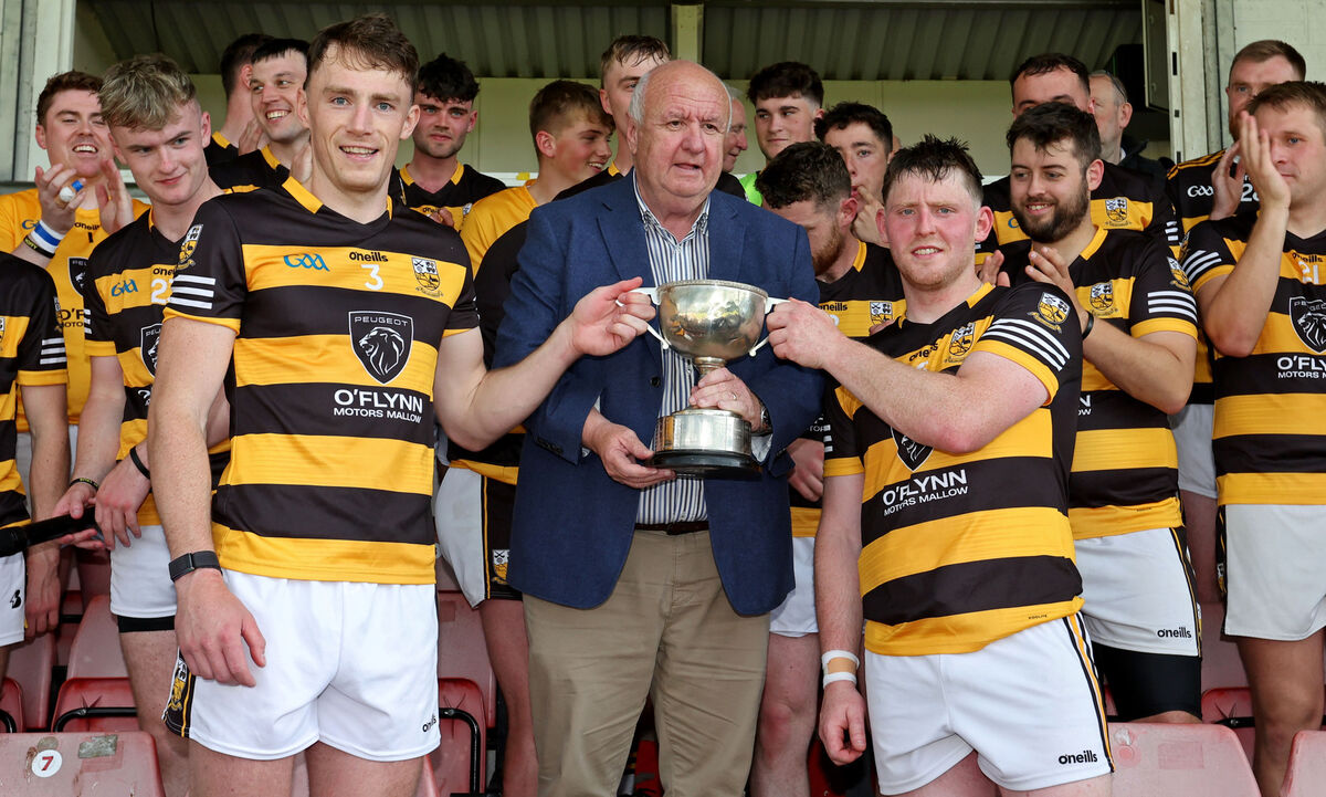  Noel O'Callaghan, Vice Chairperson Cork Gaa presents the Cup to Kevin Lenehan and Chris O'Toole, Buttevant.